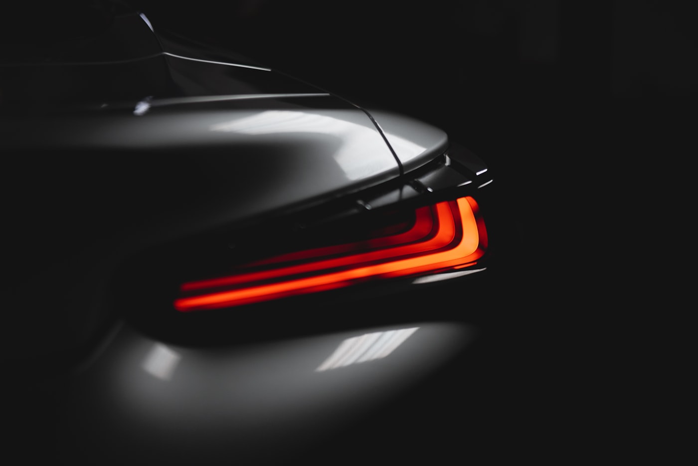 Professional car detailing results showing a flawless glossy finish on a black sports car